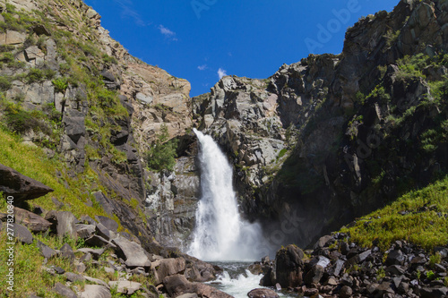 Waterfall in Altay mountains. Beautiful nature landscape. Popular touristic distination. © Yulia