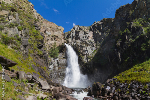 Waterfall in Altay mountains. Beautiful nature landscape. Popular touristic distination.