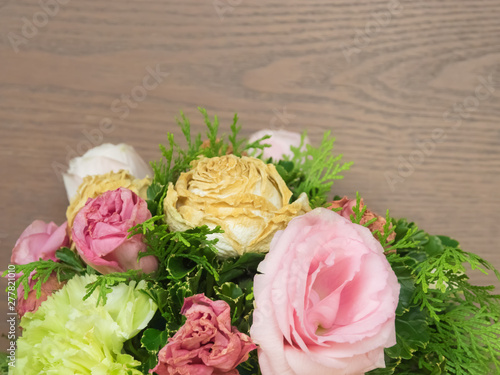 Bouquet of mixed flowers on wood background  Roses  Carnation  Eustoma  dry flowers.