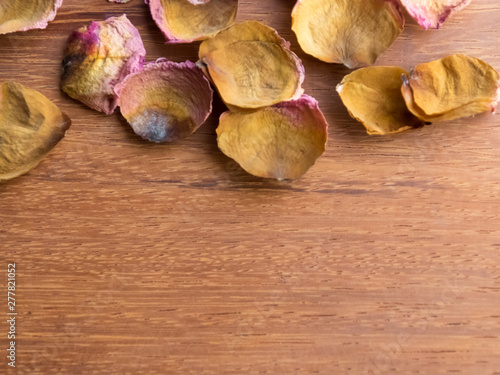 Dried Roses on Wood Background.