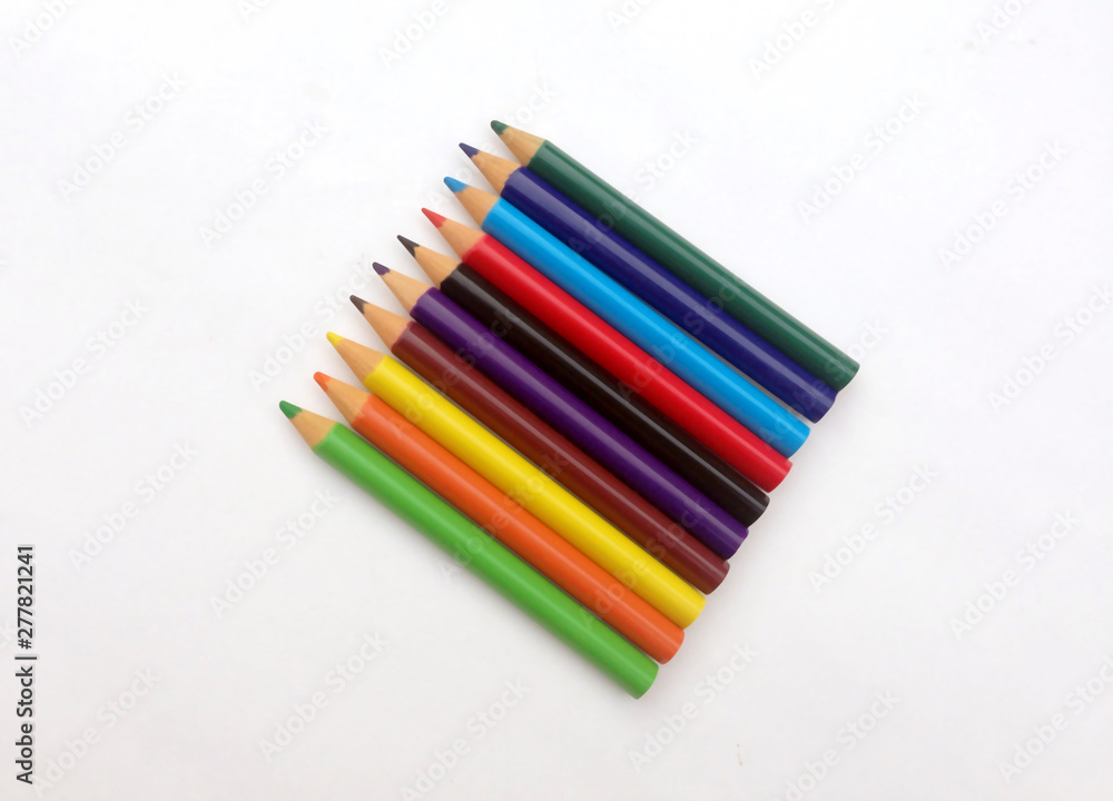 many different colored pencils on a white background. many different colored pencils on a white background.