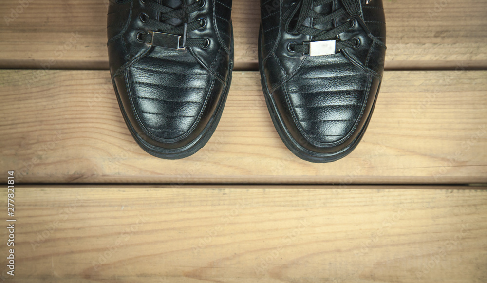 Black leather shoes on wooden floor. Black leather shoes on wooden floor.