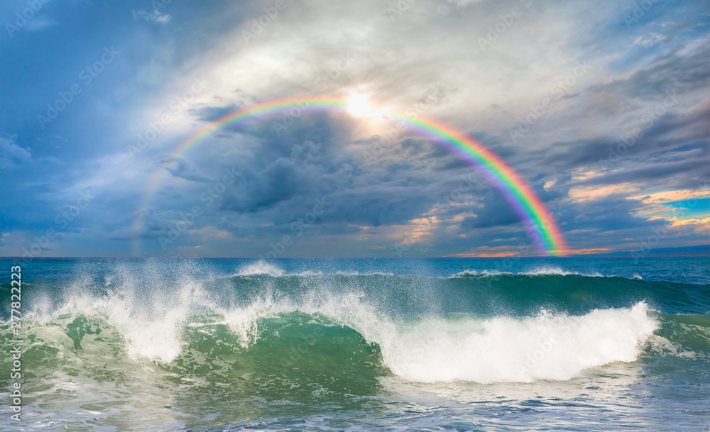 Rainbow over the stormy sea after rain Stock Photo | Adobe Stock