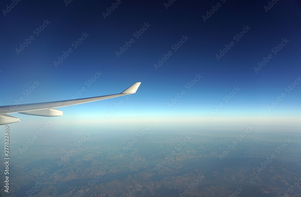 Beautiful view from the window of the aircraft. Concept and copyspase for travel, holidays and vacation. Sea, mountains, clouds, coastline, horizon, blue sky through the eyes of a traveler. Beautiful view from the window of the aircraft. Concept and copyspase for travel, holidays and vacation. Sea, mountains, clouds, coastline, horizon, blue sky through the eyes of a traveler.