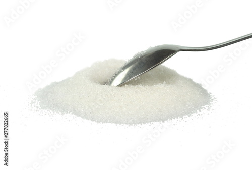 Heap of granulated sugar in a spoon isolated on white background.