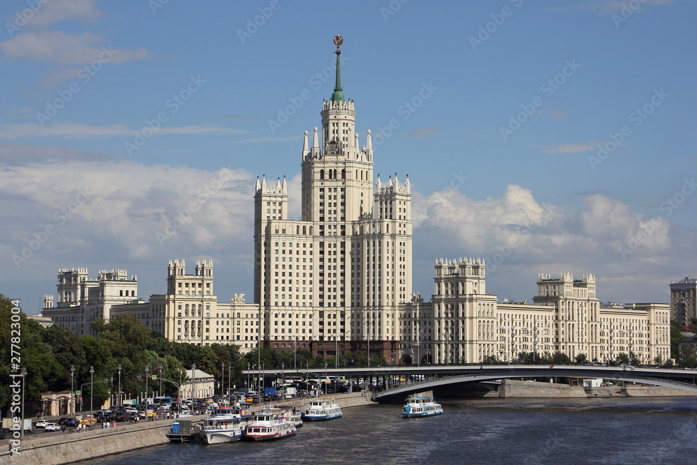 Russia, Moscow, Moscow river, Stalin Skyscraper and bridge on Kotelnicheskaya embankment in center of Moscow on blue sky background, view in Sunny summer day