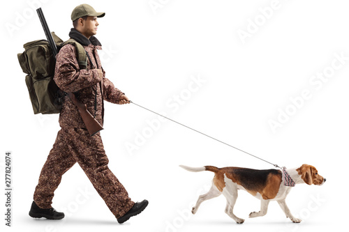 Professional hunter walking with a beagle dog