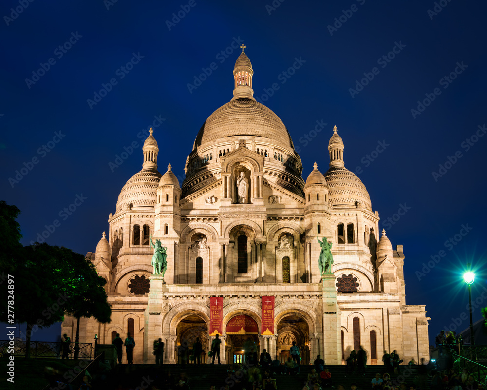 View of Basilica Sacre Coeur in Montmartre at night. Copy space in sky.