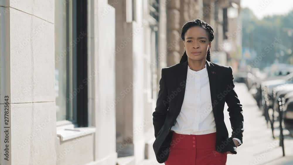 African American business woman in city walking serious face sad. Attractive businesswoman in despair. Looking sad around old town. African American business woman in city walking serious face sad. Attractive businesswoman in despair. Looking sad around old town.