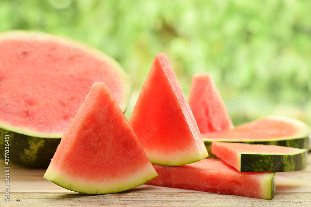 Watermelon parts or tiles without kernel by picnic in garden