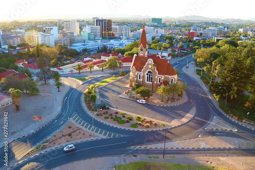 Windhoek,Namibia.April 2019.The Christ Church or Christuskirche is a historic Lutheran church.It was designed by architect Gottlieb Redecker,dedicated in 1910 .Arial city view of Windhoek at sunset.