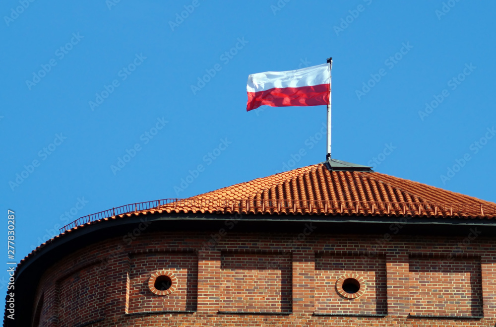 Polish national flag on the top of roof Wawel tower.