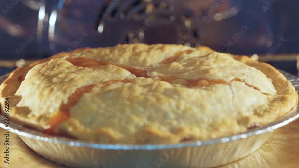 Peach pie nearly done, golden brown and bubbling in a blue oven. Perfect for Summer. Peach pie nearly done, golden brown and bubbling in a blue oven. Perfect for Summer.