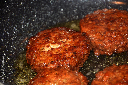 crispy meatballs fry in oil in a pan detail and macro shot, ready to eat meatloaf in a pan