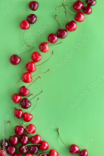Tasty cherry on light green paper background