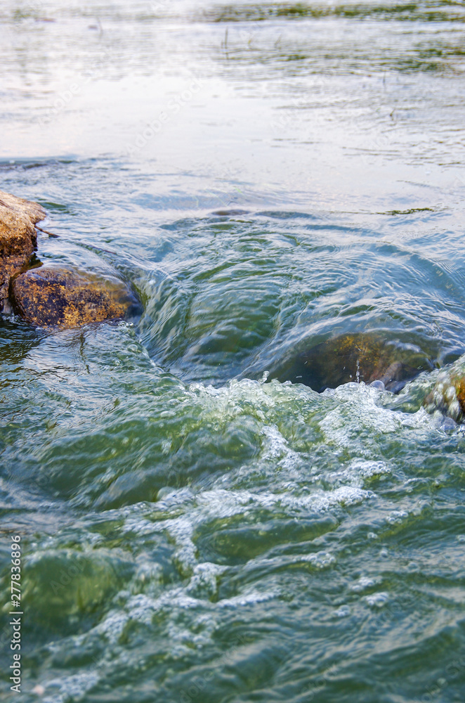Fast flowing water in the mountain river Fast flowing water in the mountain river
