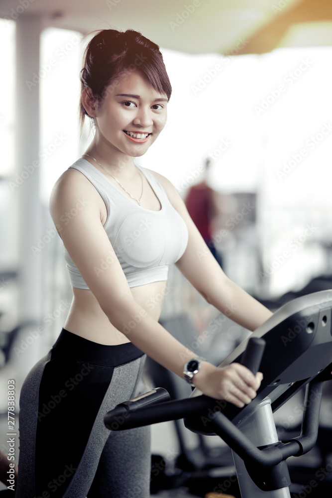 asian woman working out at gym with treadmill asian woman working out at gym with treadmill