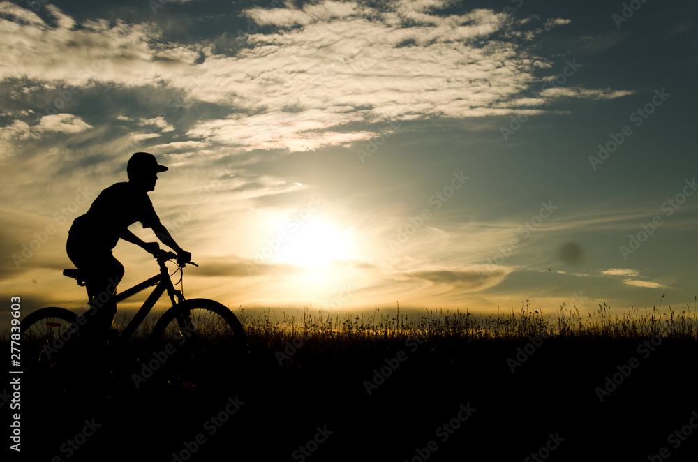 cyclist silhouette at sunset, bicycle