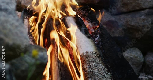 Slow motion close-up shot of campfire, camera on slider.