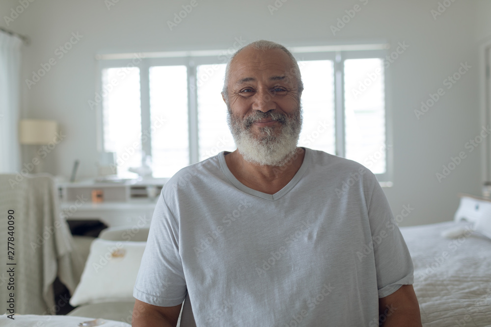 Man sitting inside white room while smiling Man sitting inside white room while smiling