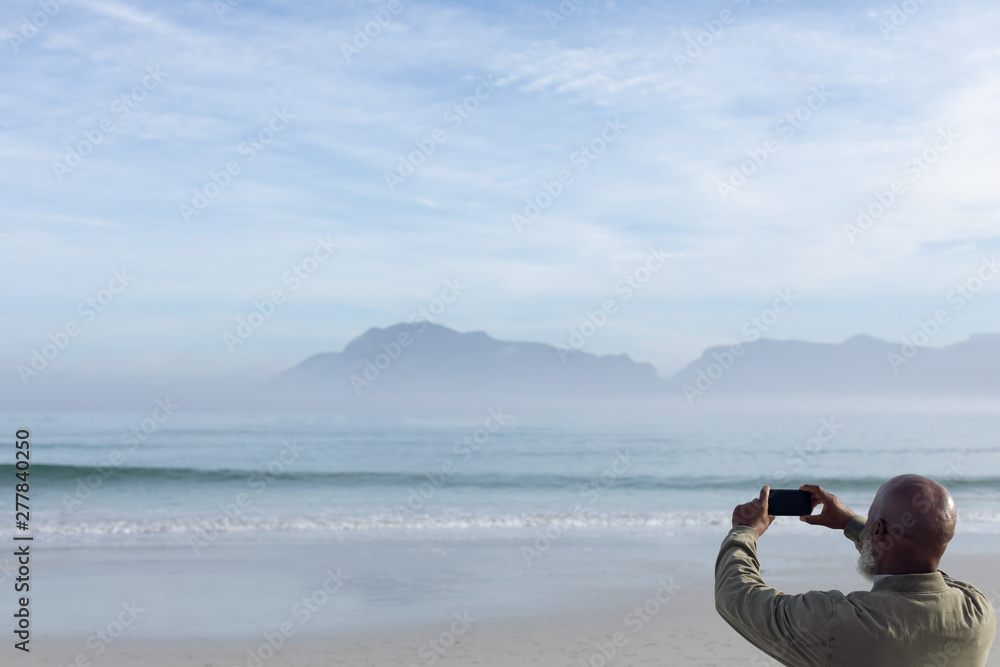 Man taking a picture at the beach