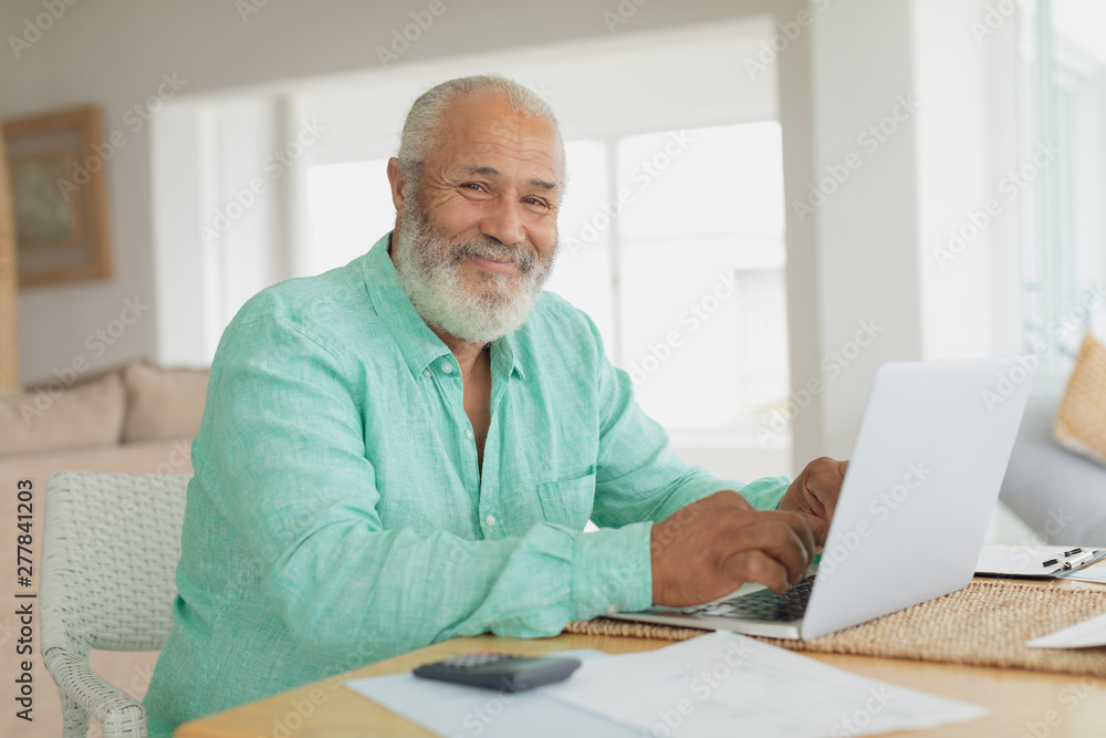 Man using laptop on a table Man using laptop on a table