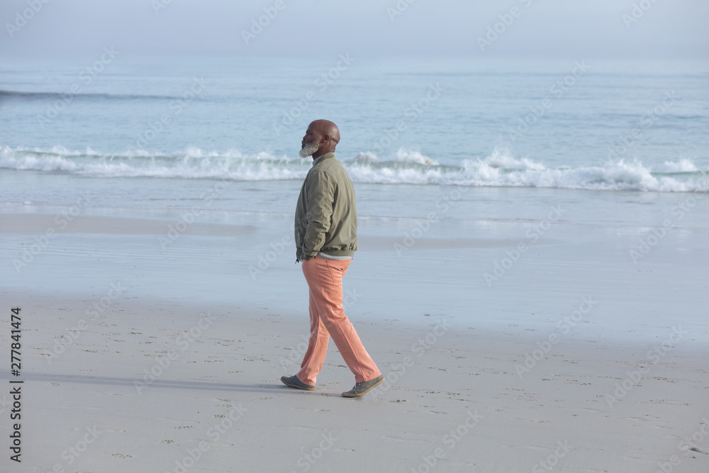 African-American man walking at the beach