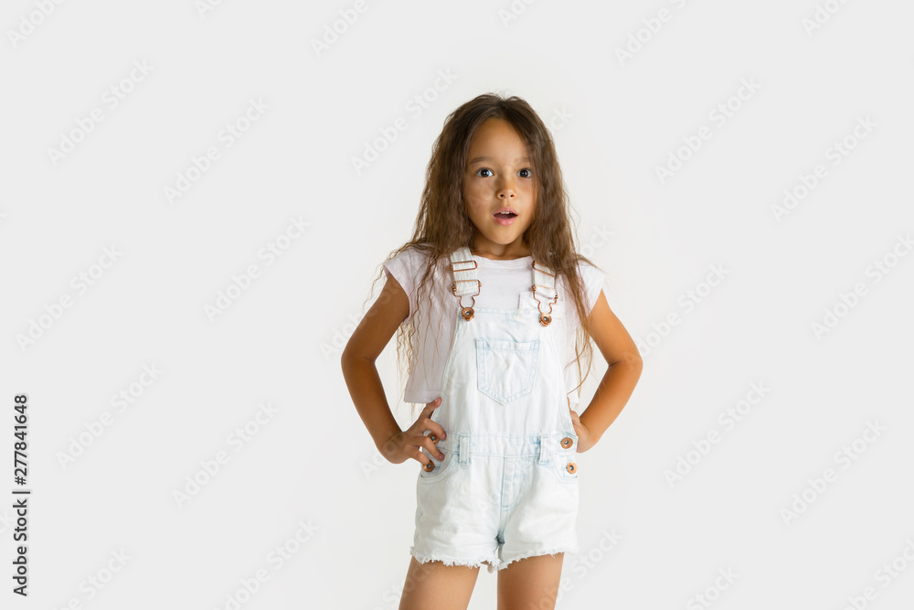 Beautiful female half-length portrait isolated on white studio background. Little emotional asian girl wearing white. Facial expression, human emotions, advertising concept. Wondered, astonished. Beautiful female half-length portrait isolated on white studio background. Little emotional asian girl wearing white. Facial expression, human emotions, advertising concept. Wondered, astonished.