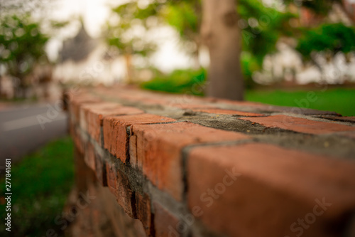 close up red brick wall pattern texture in garden on sunshine day. selective focus.