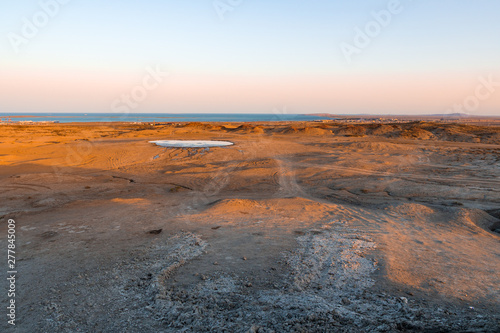 Mud volcano crater at sunset time