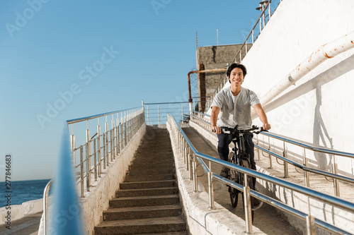 Young asian man riding a bicycle