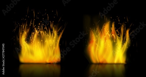 Realistic fire with sparks on dark background. Isolated vector illustration.