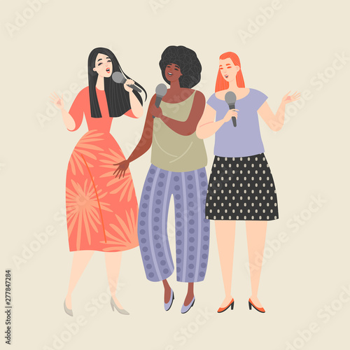 Three young women with microphones singing a song at a karaoke party