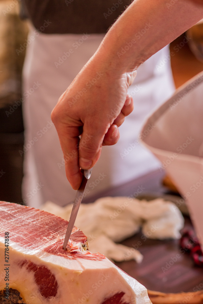 Obraz premium Iberian ham cut with knife