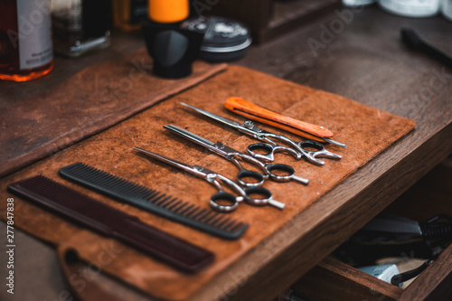 Barber shop tools on old wooden background.Barber vintage tools for beard grooming in retro barber shop