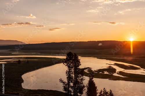 Early Morning in Hayden Valley, Yellowstone National Park, as the sun is just peaking over the horizon, while a thin layer of mist is still covering the land. photo