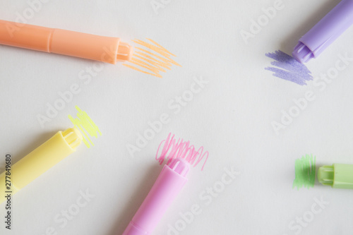Overhead view of colorful markers on grey background