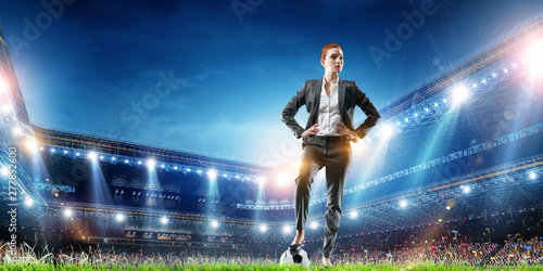 Business lady on football stadium. Mixed media © Sergey Nivens