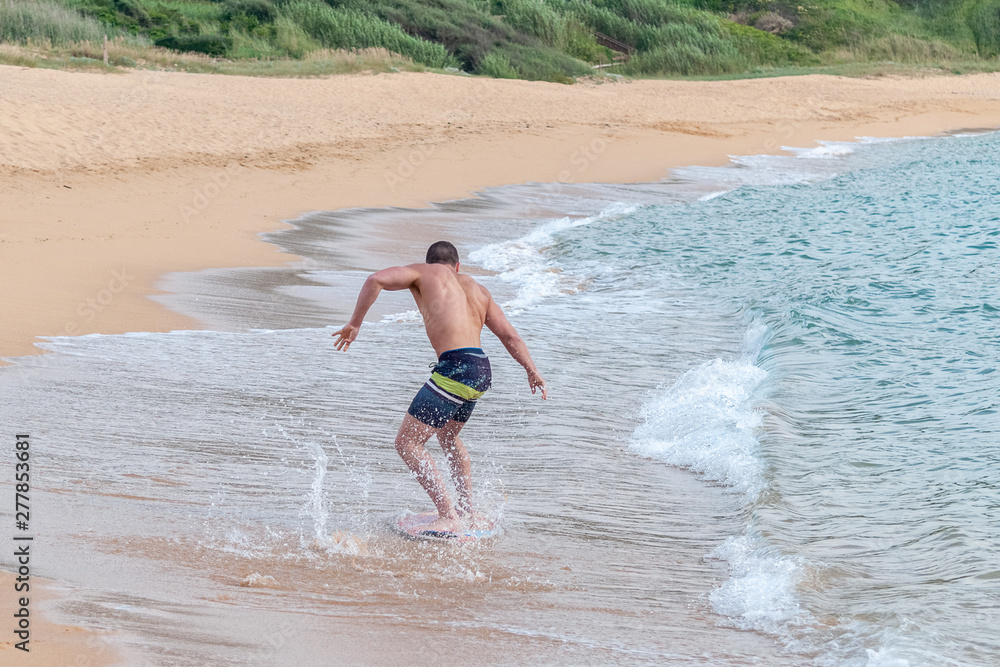 Fototapeta premium young guy on the board on the waves