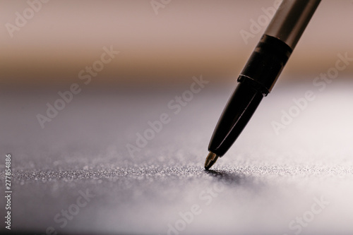 automatic black plastic ballpoint pen with clipping path on black background. close up.