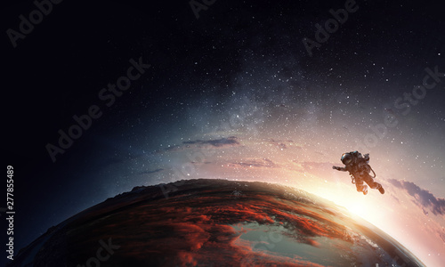 Fototapeta Naklejka Na Ścianę i Meble -  Astronaut in space on planet orbit.