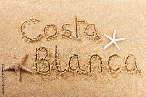 Costa Blanca spain word written in sand sign writing drawing drawn on a sunny spanish summer beach with starfish holiday vacation travel destination message photo photo