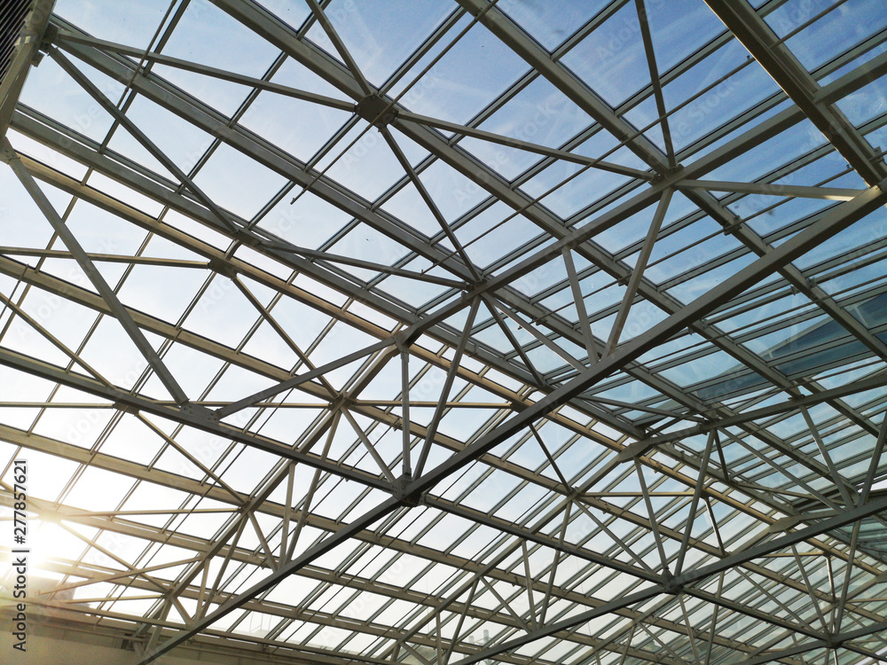 Glass roof shopping center or airport. Architecture and design of the roof in the style of high-tech. The sun shines skok glass Glass roof shopping center or airport. Architecture and design of the roof in the style of high-tech. The sun shines skok glass