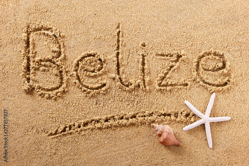 Belize word written in sand sign writing drawing drawn on a sunny summer beach with starfish holiday vacation travel destination message photo