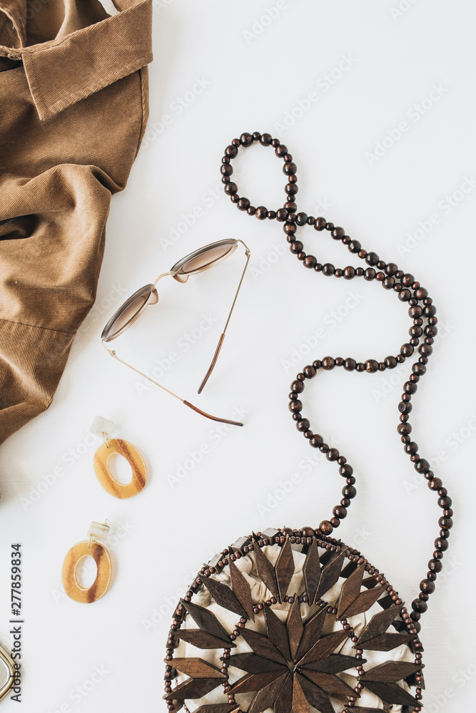 Fashion composition with women's clothes and accessories on white background. Shirt, purse, earrings, sunglasses. Flat lay, top view modern stylish lifestyle blog. Fashion composition with women's clothes and accessories on white background. Shirt, purse, earrings, sunglasses. Flat lay, top view modern stylish lifestyle blog.