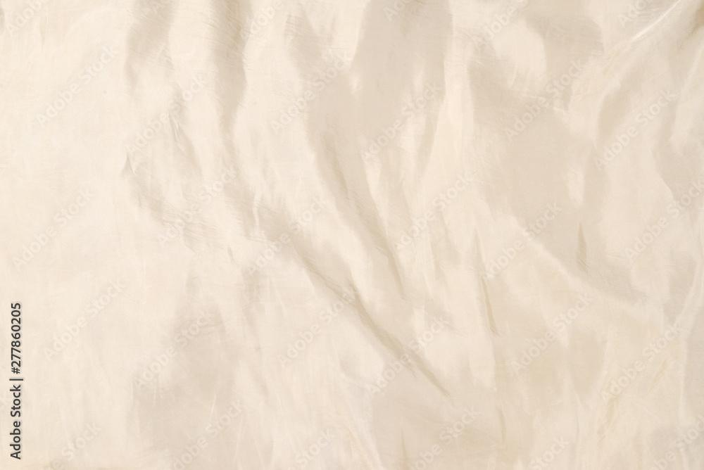 Soft smooth beige silk fabric background. Fabric texture. Soft smooth beige silk fabric background. Fabric texture.
