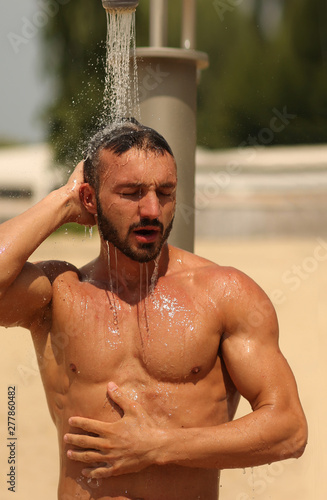 Beach, Abs , Guy. Man. Model. Shower, wash Male. Beach, Resort. Summer, Sexy, sexually, resort. Sand, Fitness. Health. Body, abs, chest, torso, fitness model, manly, brutal, shorts, Muscular, power	