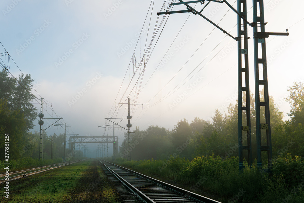 railway tracks going into the fog