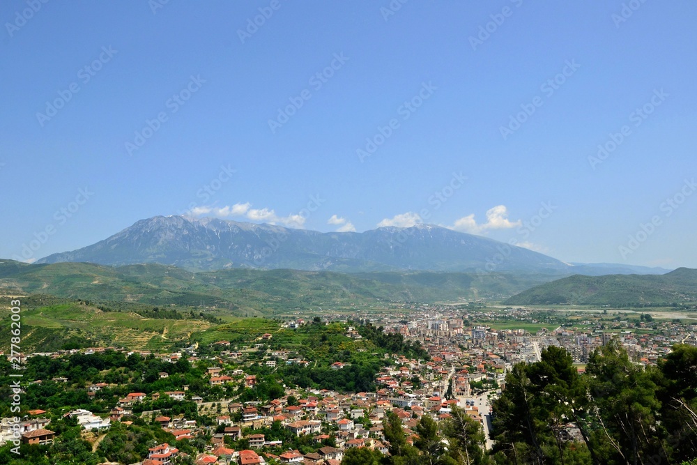 The albanian city of Berat, designated a UNESCO World Heritage Site in 2008. Top view from the Berat Castle to the city center and Tomorr Mountain  (Mount Tomorr) in the background. Albania