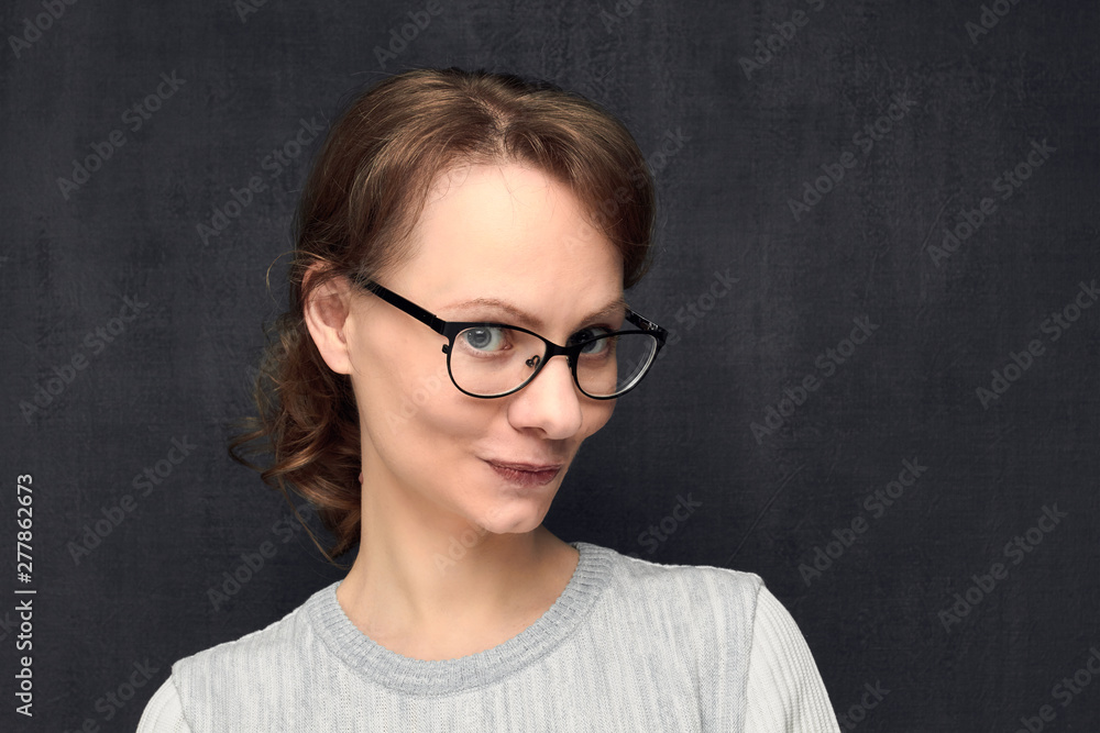 Portrait of cute and intrigued young woman with glasses Portrait of cute and intrigued young woman with glasses